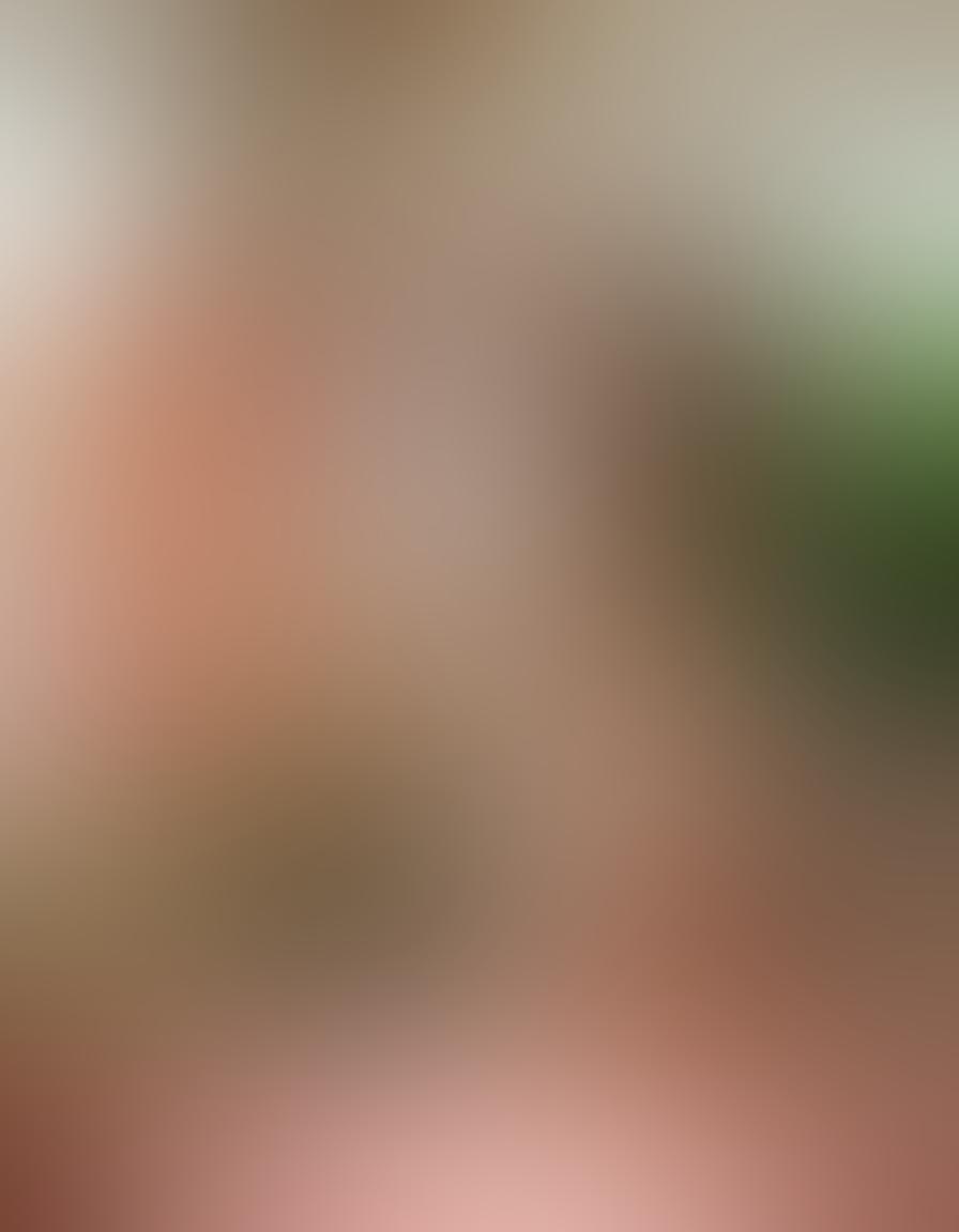 A serene art studio filled with natural light, showcasing diverse nude sculptures that celebrate body positivity. In the foreground, a joyful artist paints a vibrant canvas depicting various body shapes, surrounded by flora and soft textiles. The atmosphere radiates creativity and acceptance, encouraging self-love and expression. Use warm tones to evoke a sense of well-being. super-realistic. vibrant colors.